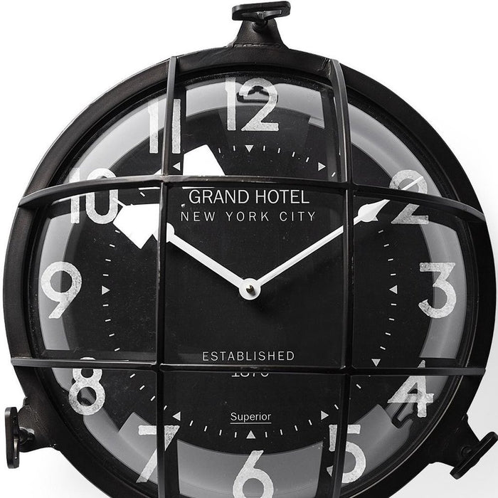 Black clock with 'Grand Hotel New York City' branding on a white background