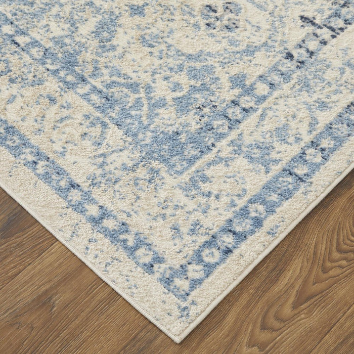 Close-up of a blue and beige patterned rug on a wooden floor