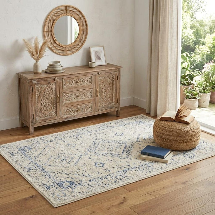 Wooden sideboard with decorative items in a room with a rug and window.
