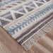 Patterned rug with fringes on a wooden floor