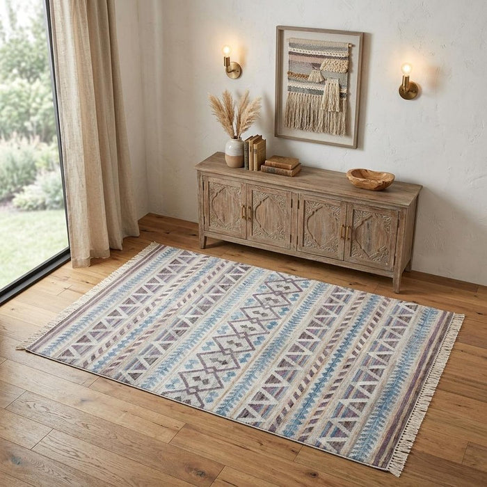 Patterned rug on a wooden floor with a wooden sideboard and decor items.