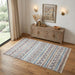 Patterned rug on a wooden floor with a wooden sideboard and decor items.